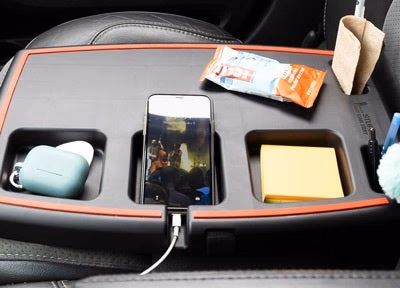 car tray with phone snacks and airpods