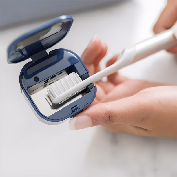 close up of hands holding an open blue bril toothbrush case