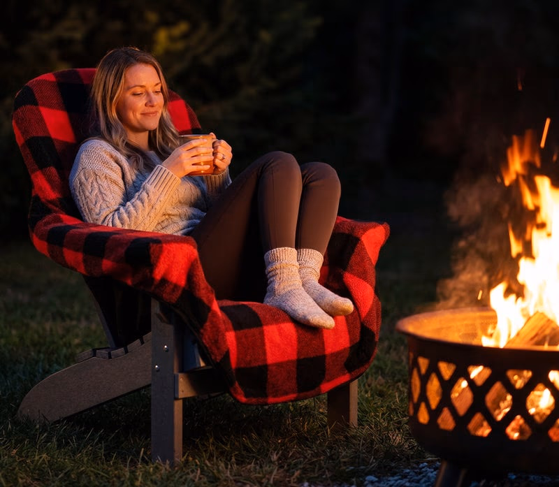 cozy chair blanket on woman by firepit