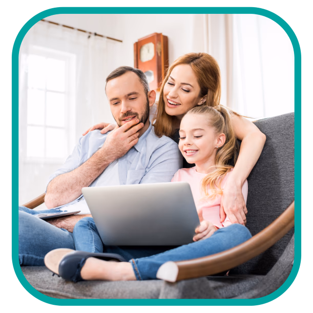 family using laptop together on couch