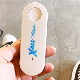 hand holding a white x all device with a power button