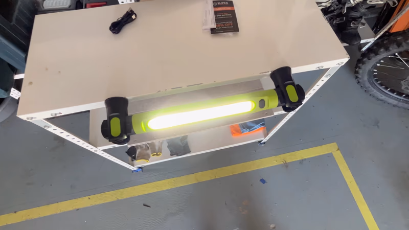 magnetic work light attached to a metal workbench