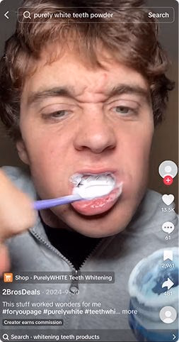 man applying purely white teeth powder with toothbrush