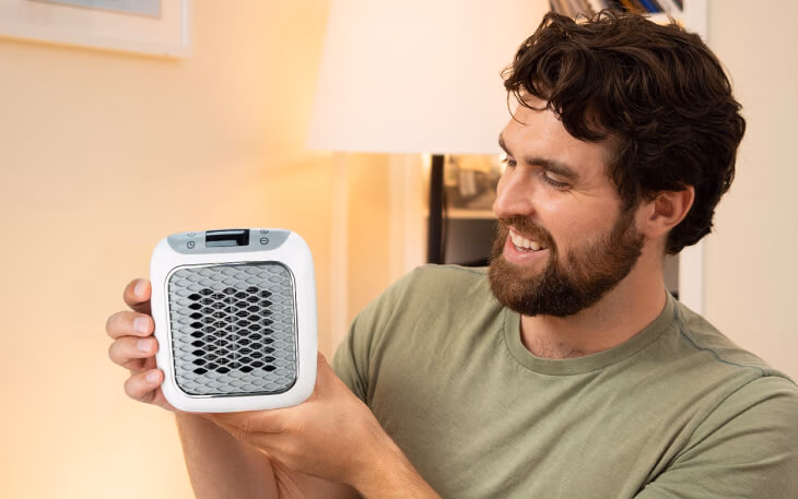 man holding heatwell portable heater