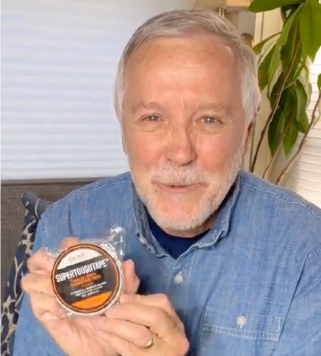 man holding supertoughtape roll