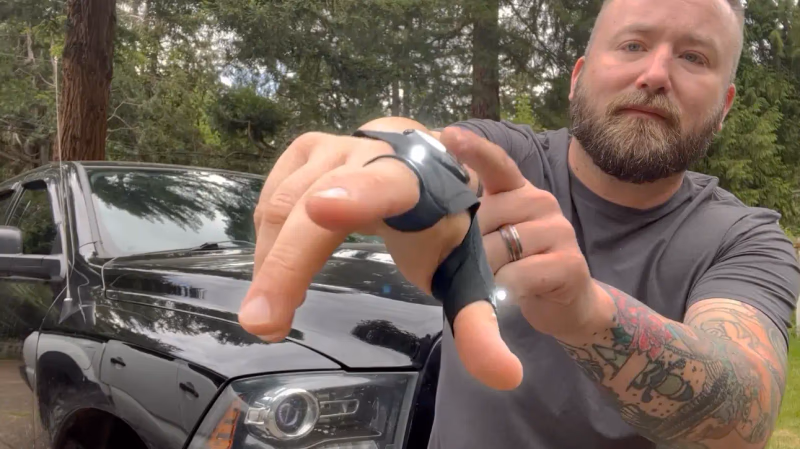 man showing supergloves led flashlight gloves