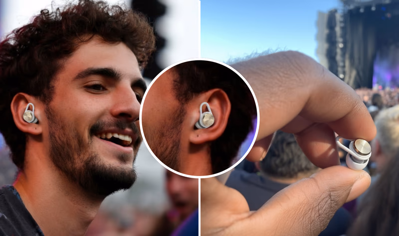 man wearing hears earbuds at a concert