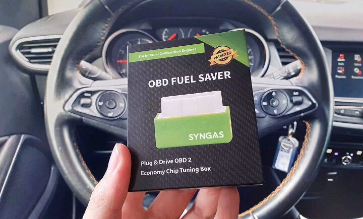 obd fuel saver box held in front of car dashboard