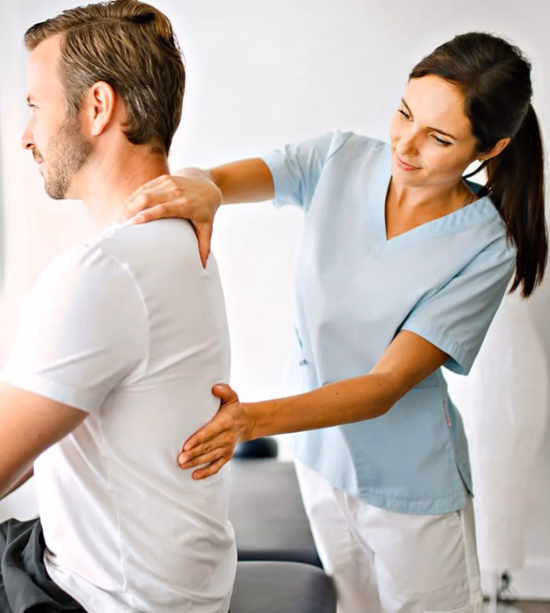 physical therapist massaging mans back