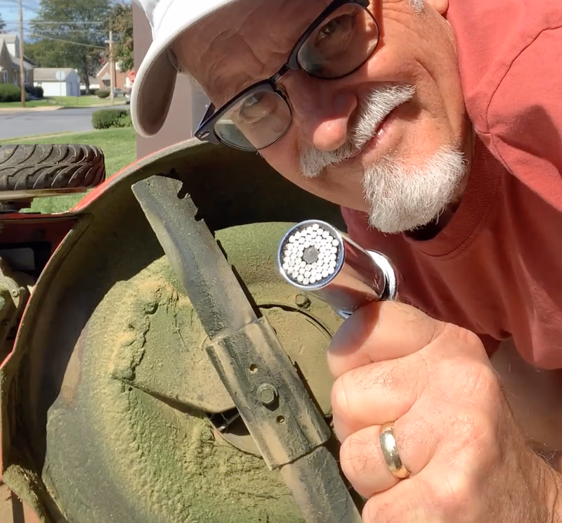 supersocket tool held near lawnmower blade