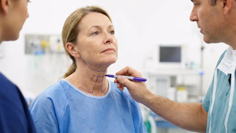 womans neck being marked for cosmetic procedure