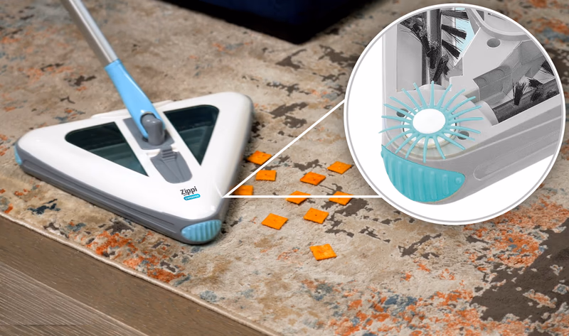 zippi sweeper cleaning crumbs on rug